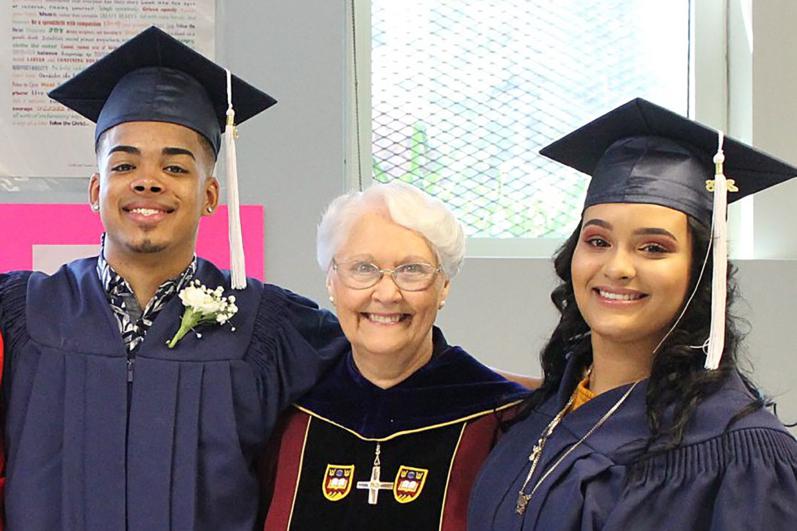 Sister Gilfeather with two student graduates