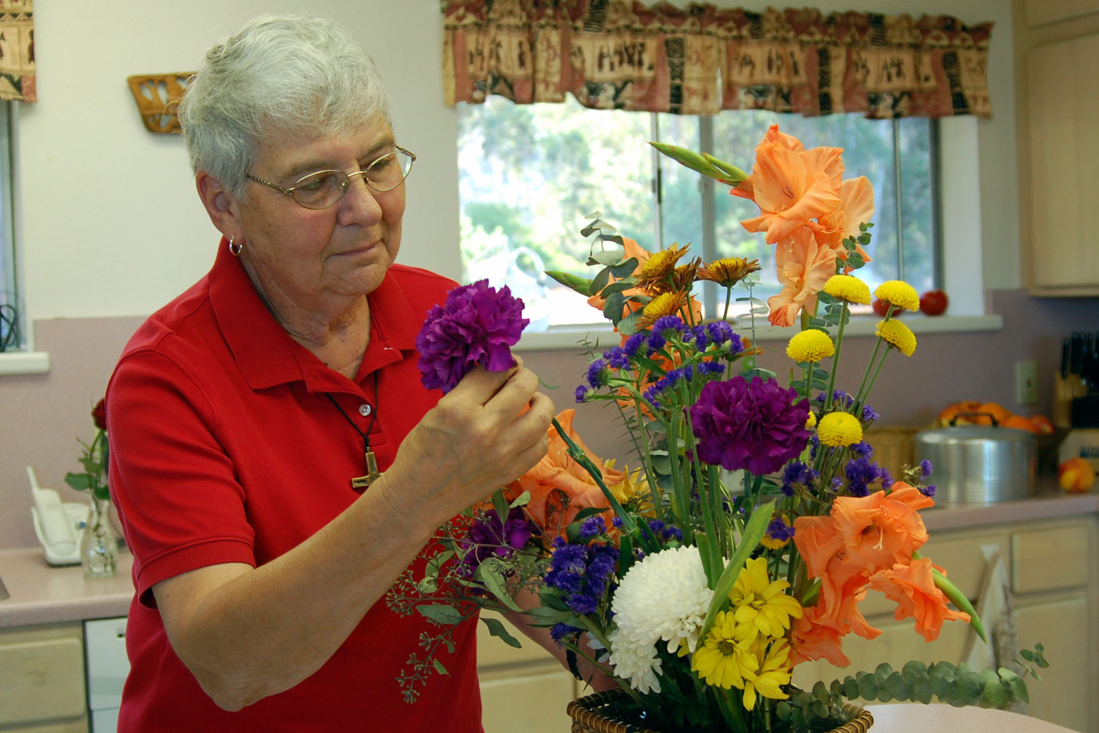 Sr. Michelle Henault arranges flowers at the Carmel House of Prayer.