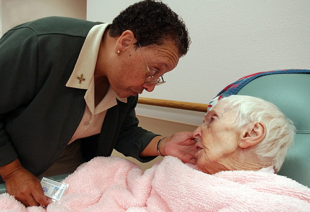 Sister Martin de Porres Coleman, SNDdeN cares for a Sister of Notre Dame de Namur at Mercy Retirement and Care Center.