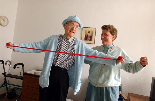 Sister Phyllis (right) helps Sister Marie Veronica exercise.