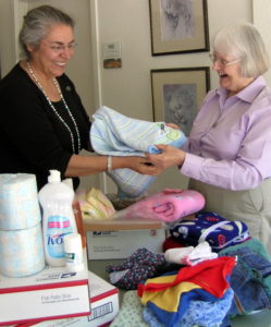 Chenna Bonequi and Sr. Kay box supplies to send to the Notre Dame =Sister in Zimbabwe for distribution to families in need.