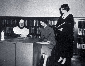 Sister Alice Gertrude Keating, SNDdeN speakingwith two students in 1952.