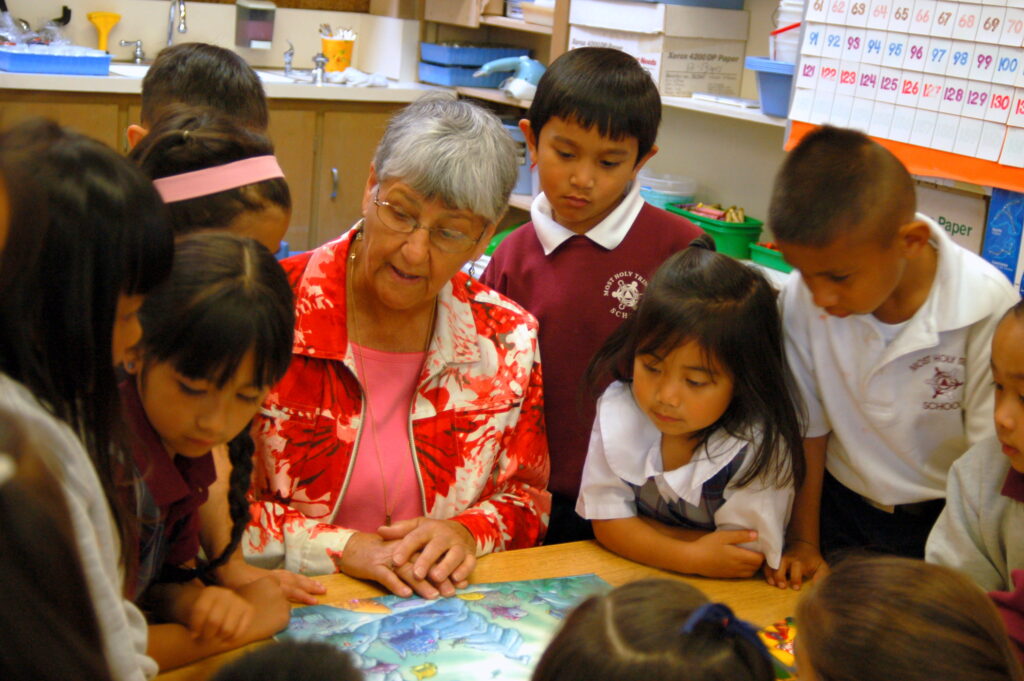 Sister Beth Plesche captures the attention of young students.