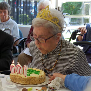 Sr. Julie Bellefeuille blows our her 100th birthday candles