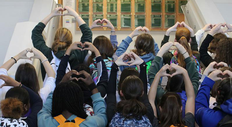Students making a heart shape