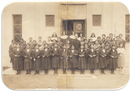 American Sisters of Notre Dame de Namur standing with their students