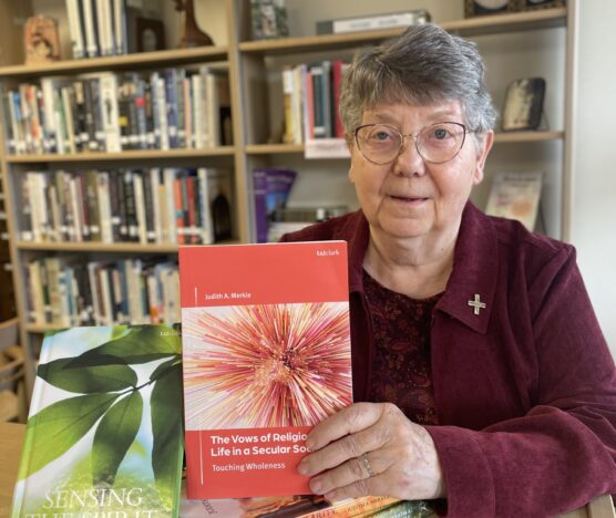 Sister Judith A. Merkle, SNDdeN of the Ohio Province holds her latest book, "The Vows of Religious Life in a Secular Society."