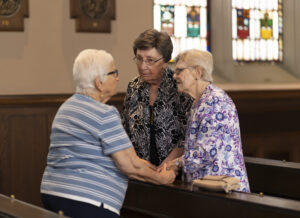 trio of women talking Emmanuel Jubilee 2026 churchgoers