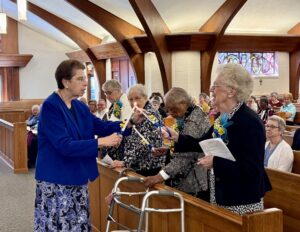 Sister Pat O'Brien lighting candles of jubilarinas Windsor Jubilee 2026