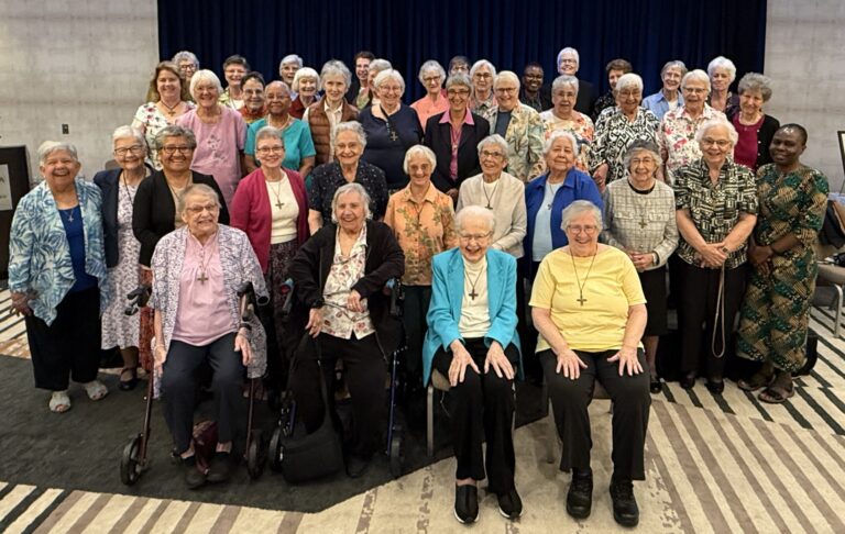 Large group of Sisters of Notre Dame de Namur standing together at California 175th Anniversary Luncheon