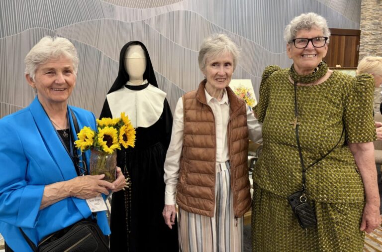 three women standing next to a pre-Vatican II nun habit displayed on a mannequin form, at California 175th Anniversary Luncheon